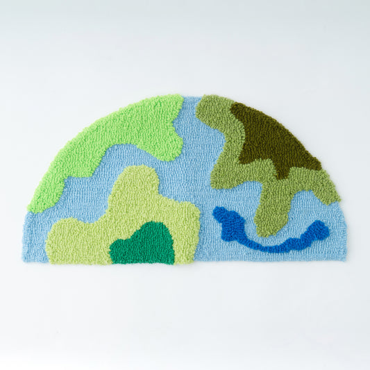 AK-2ループパイルタフティングガンを使用して制作されたサンプルラグ。地球のような半球がモチーフになったループパイルのラグ。AK-2 ループパイル タフティングガン 初心者向け電動式